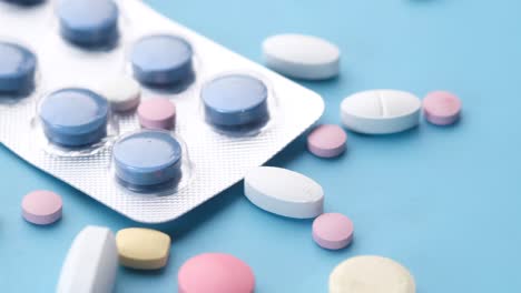 assorted pills and blister pack on a blue background