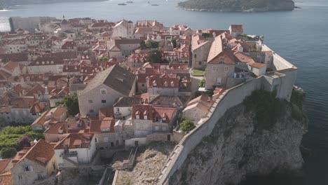 drone flying towards old town dubrovnik ancient homes