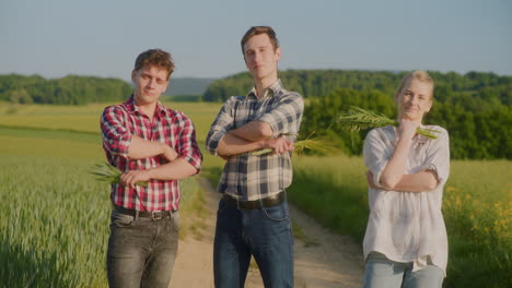three young farmers portrait shot in rural landscape
