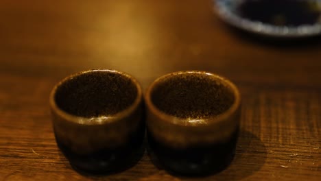 sake being poured into two cups