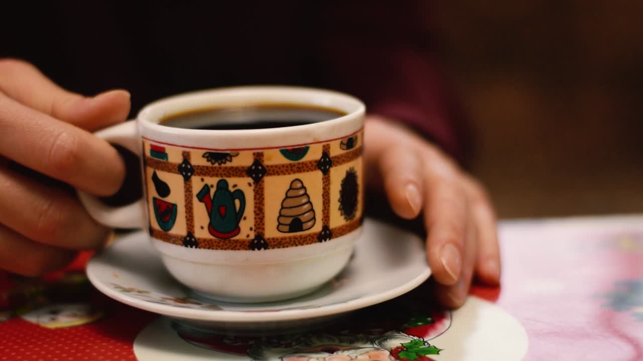 Woman drinking tea from a Christmas mug