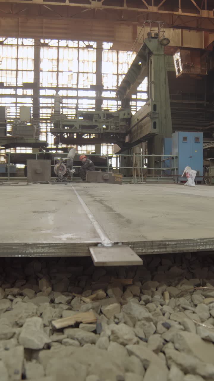 Worker performing tasks in a large industrial factory