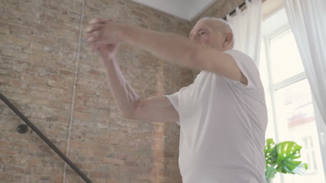 old man stretching and exercising at home 2