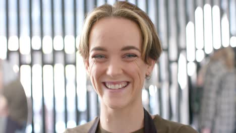 portrait of caucasian female hairdresser with bob and highlights smiling at salon, in slow motion