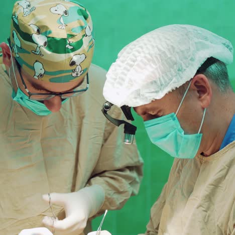 two surgeon in uniform perform operation on a patient at surgery clinic