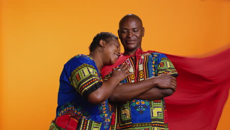 mujer afroamericana presentando a su marido como un héroe,