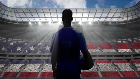 animation of rear view of football player holding ball over american flag in sports stadium