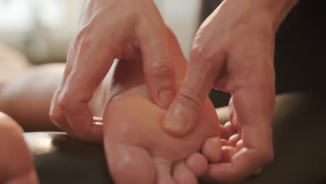 foot massage in spa salon, closeup