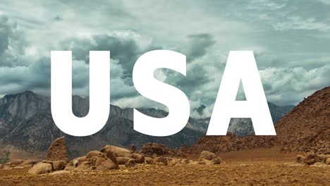 Mountains-And-Desert-Landscape-In-American-National-Park-Overlaid-With-Animated-Graphic-Spelling-Out-USA