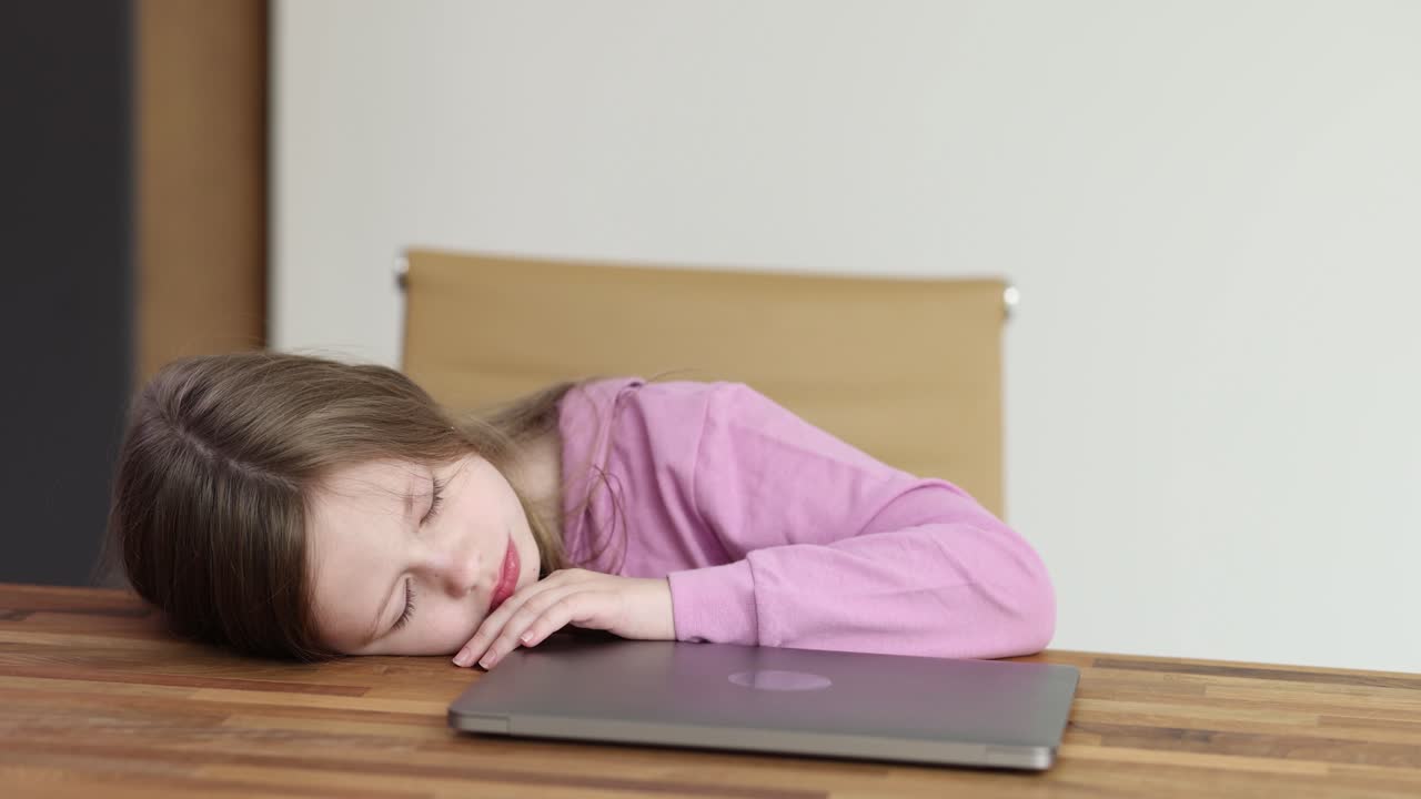 Girl sleeping on desk with laptop