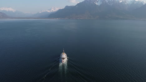 Aerial-subject-tilt-up-shot-of-a-ferry-boat-on-Lake-Geneva-near-Lausanne,-Switzerland-on-a-sunny-day