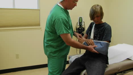 a doctor tests a teen's hurt arm