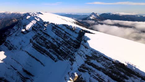 aerial views of a mountain range in the spanish pyrenees coverd by snow and with clouds in the horizon