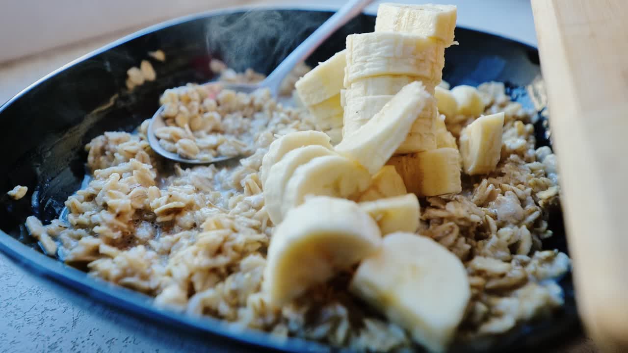 Hearty breakfast moment with warm porridge and fresh fruit in cozy kitchen