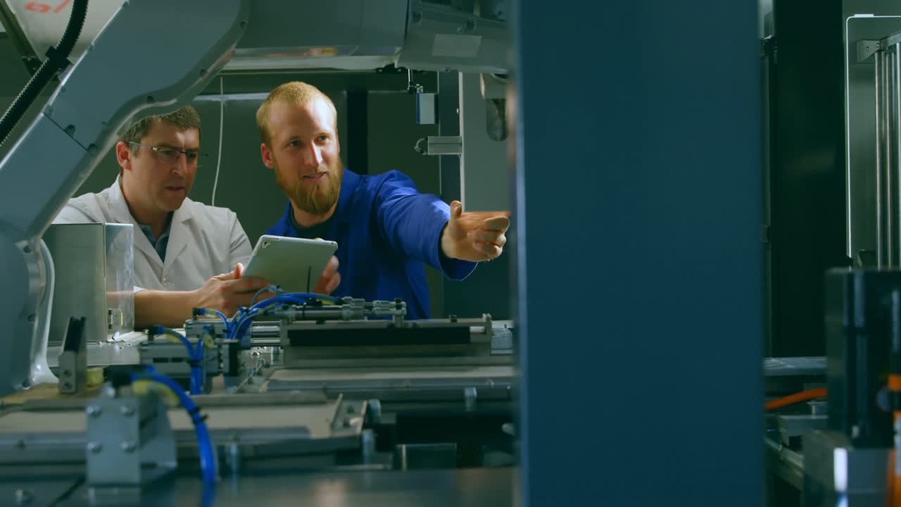Robotic engineers checking machinery in warehouse 4k