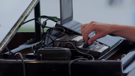 musician performing with midi keyboard and laptop on a piano