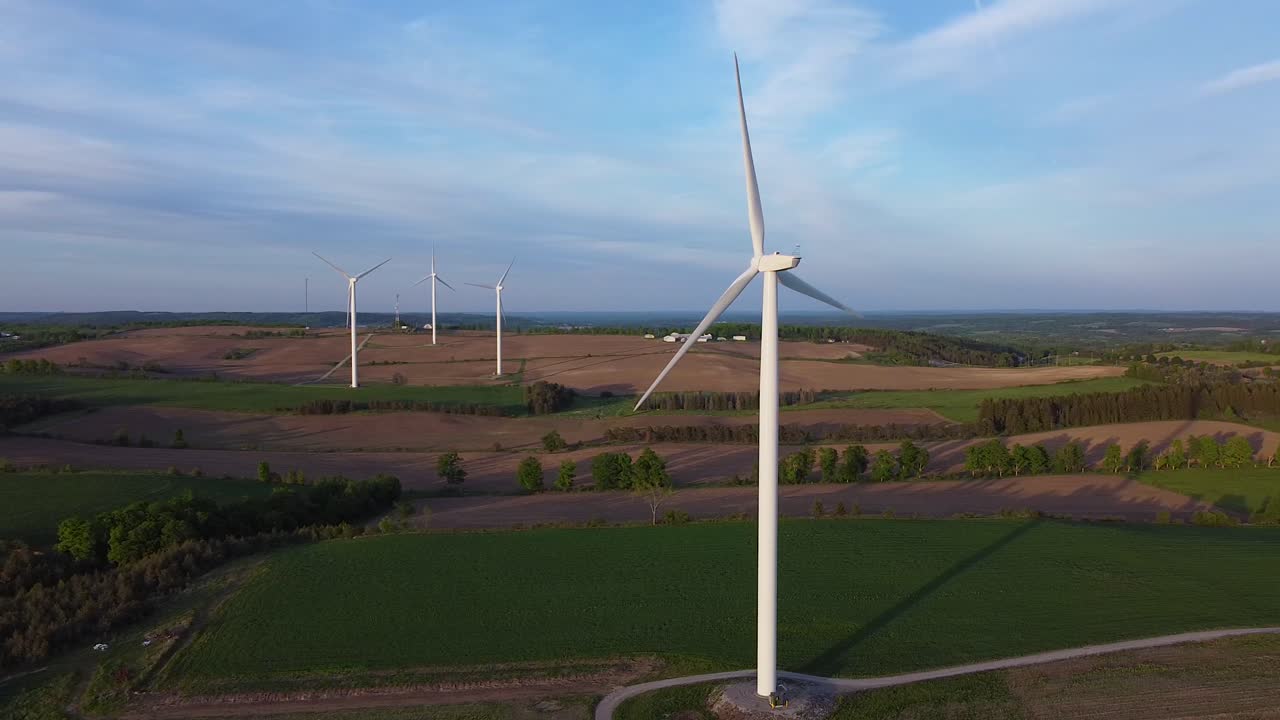 Aerial of renewable sustainable energy wind turbine farms on fields