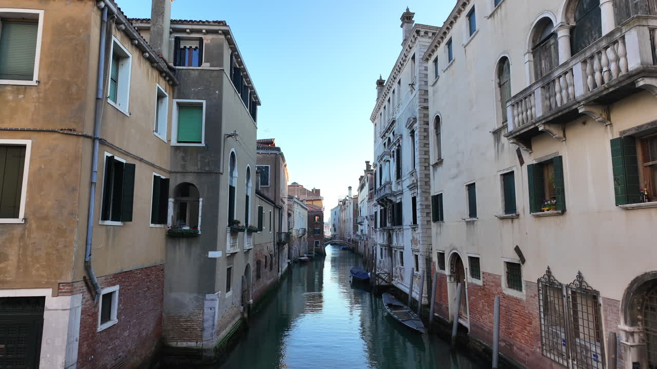 Boats docked on the side of a canal in Venice, Italy