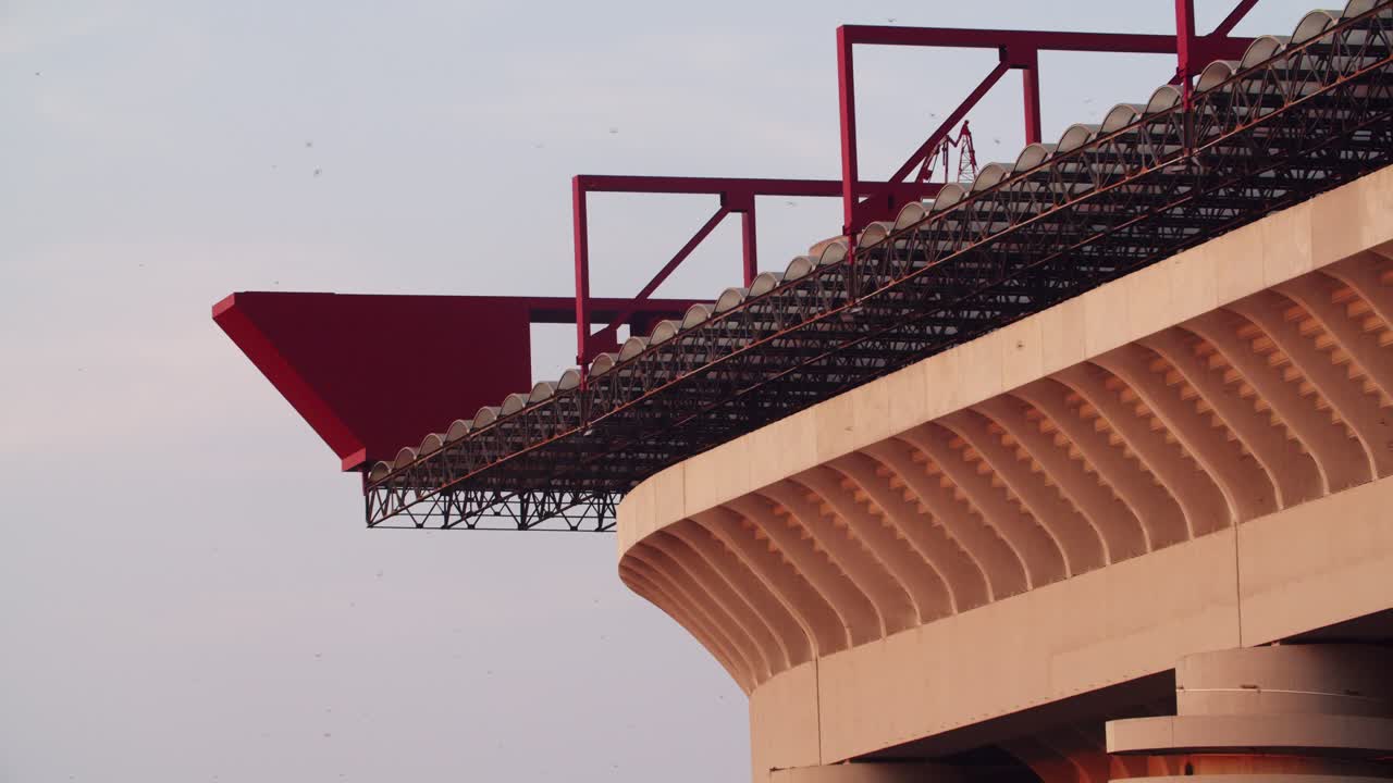 established drone aerial view of Milan’s San Siro Stadium, highlighting architectural details and swallows