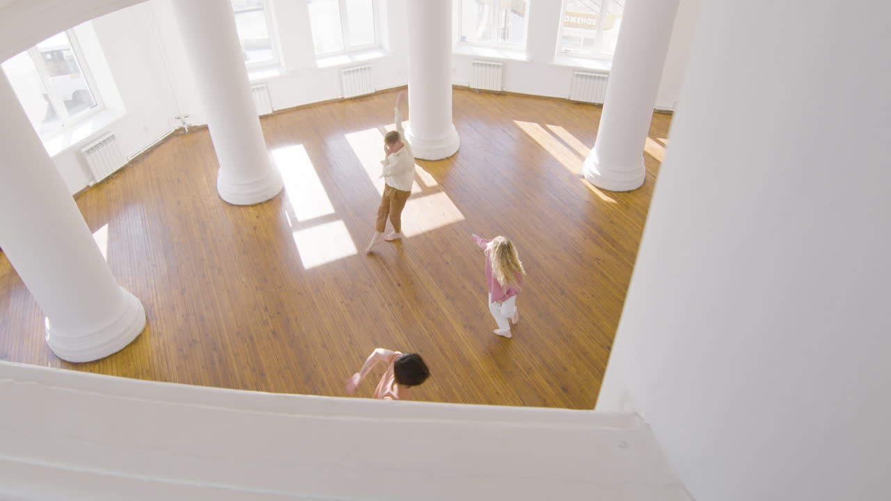 Top View Of Multiethnic Group Of Contemporary Dancers Dancing And Moving Around The Studio 2