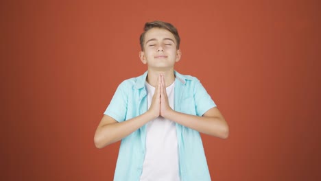 boy meditating looking at camera.