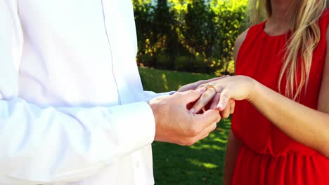 man putting an engagement ring on womans finger 4k