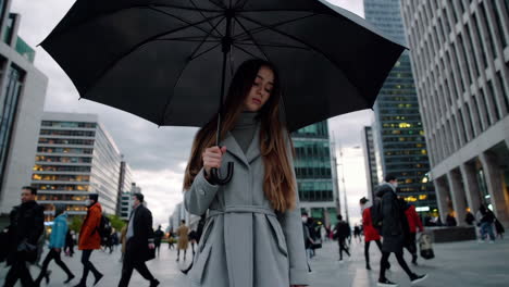 woman with umbrella in a cityscape