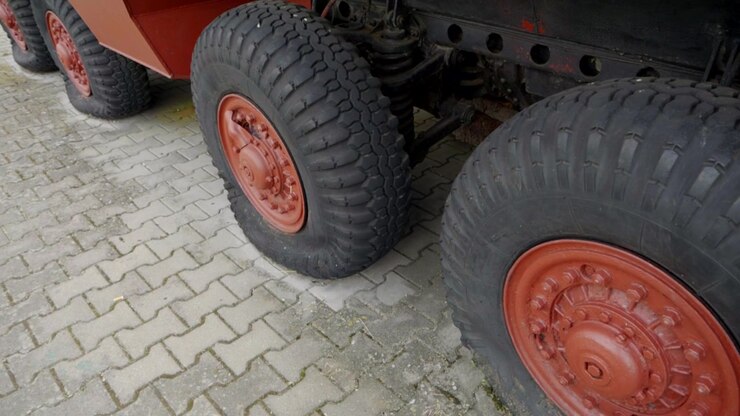 Close view of rugged wheels and tires on a historic armored vehicle displayed outdoors