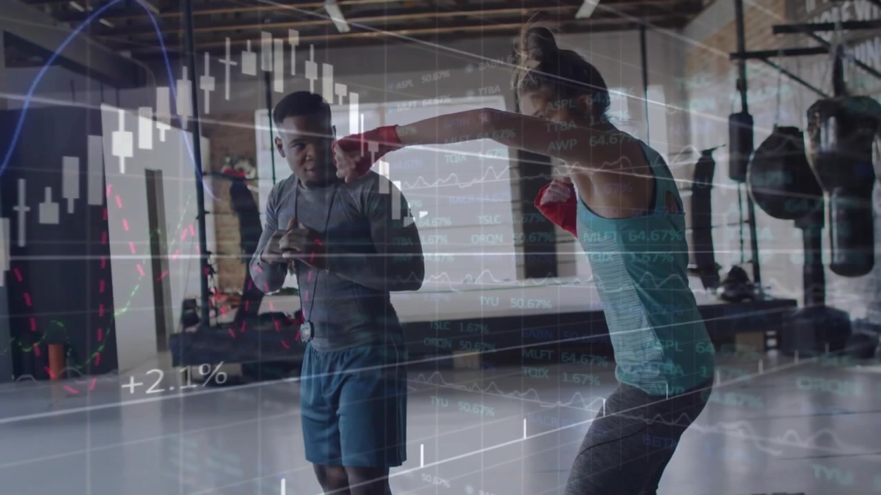 Trainer tapping device starting drill, boxer throwing jabs with red wraps, market charts overlaying