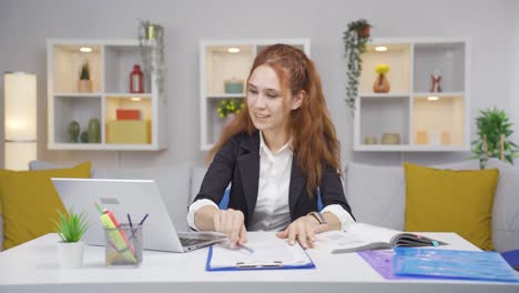 Home-office-worker-woman-happy-and-smiling.