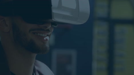 Animation-of-cross-symbols-pattern-design-over-close-up-of-biracial-man-wearing-vr-headset-at-office