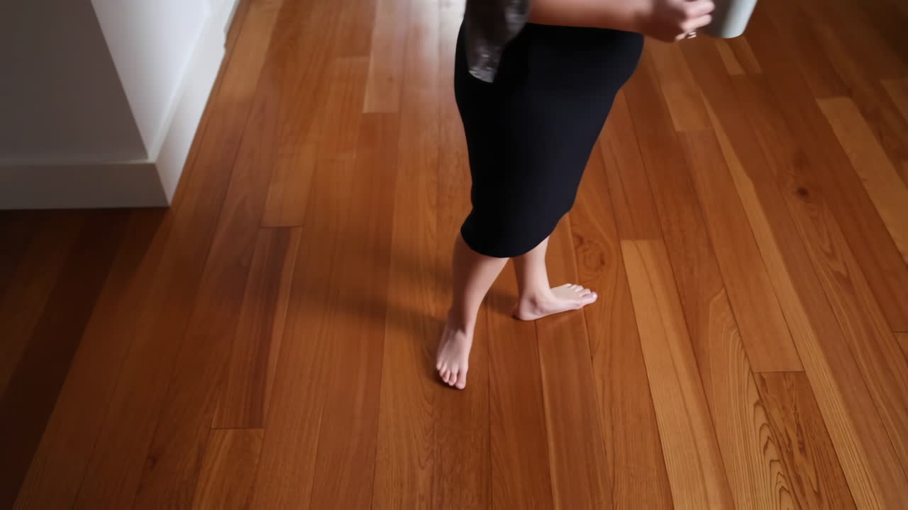 Barefoot person on wooden floor indoors
