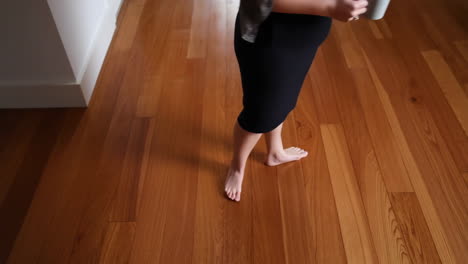 barefoot person on wooden floor indoors