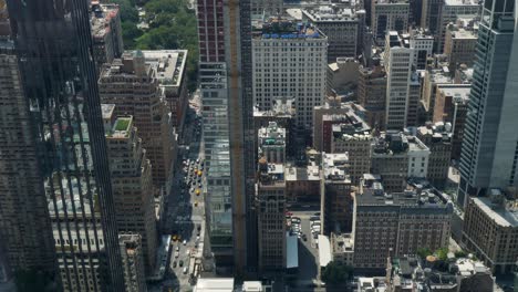 slow motion landscape of busy city intersection with cars taxi traffic transport and buildings towers skyscrapers skyline manhattan new york usa america travel urban infrastructure