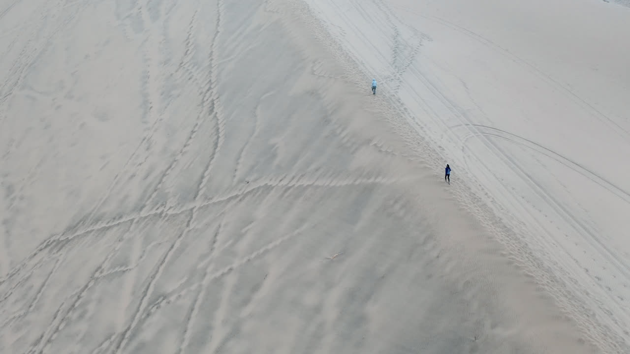 people climbing a dune. Huacachina, Peru, desert, drone aerial