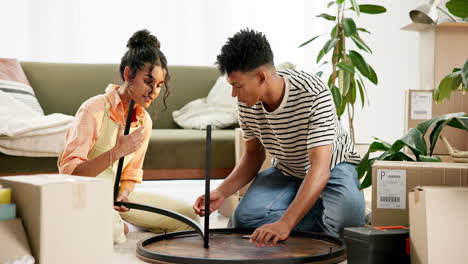 couple assembling furniture after moving