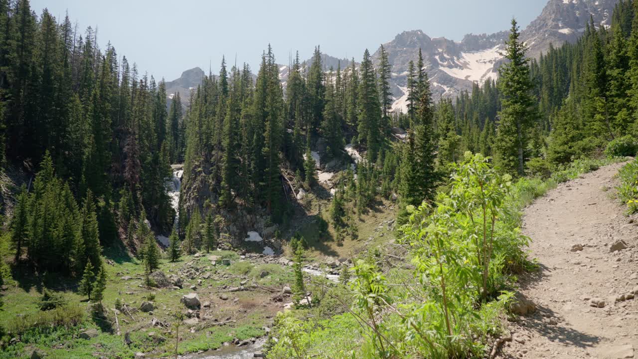Man Hiking up a dirt alpine trail | Blue Lakes Trail, Colorado