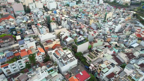 aerial drone circling a residential area of a densely populated asian city on a sunny afternoon in ho chi minh city vietnam