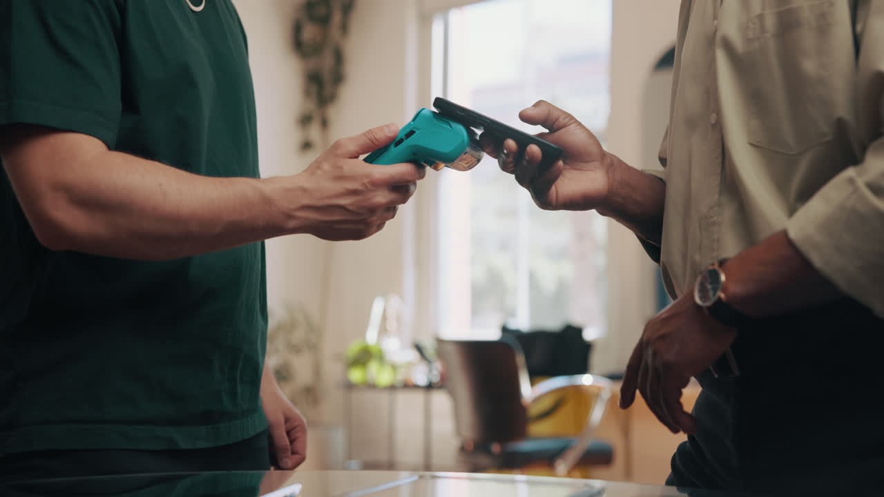 Customer Making Contactless Payment with Smartphone at POS Terminal
