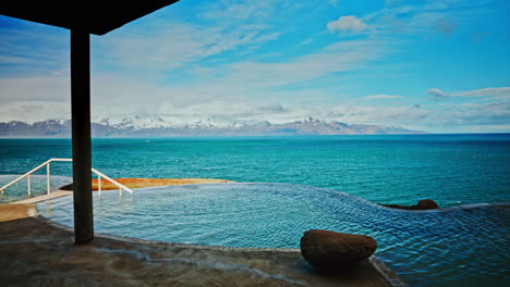 Outdoor-Icelandic-thermal-spa-with-breathtaking-view-of-the-nordic-ocean-and-majestic-snowy-mountains-the-distance