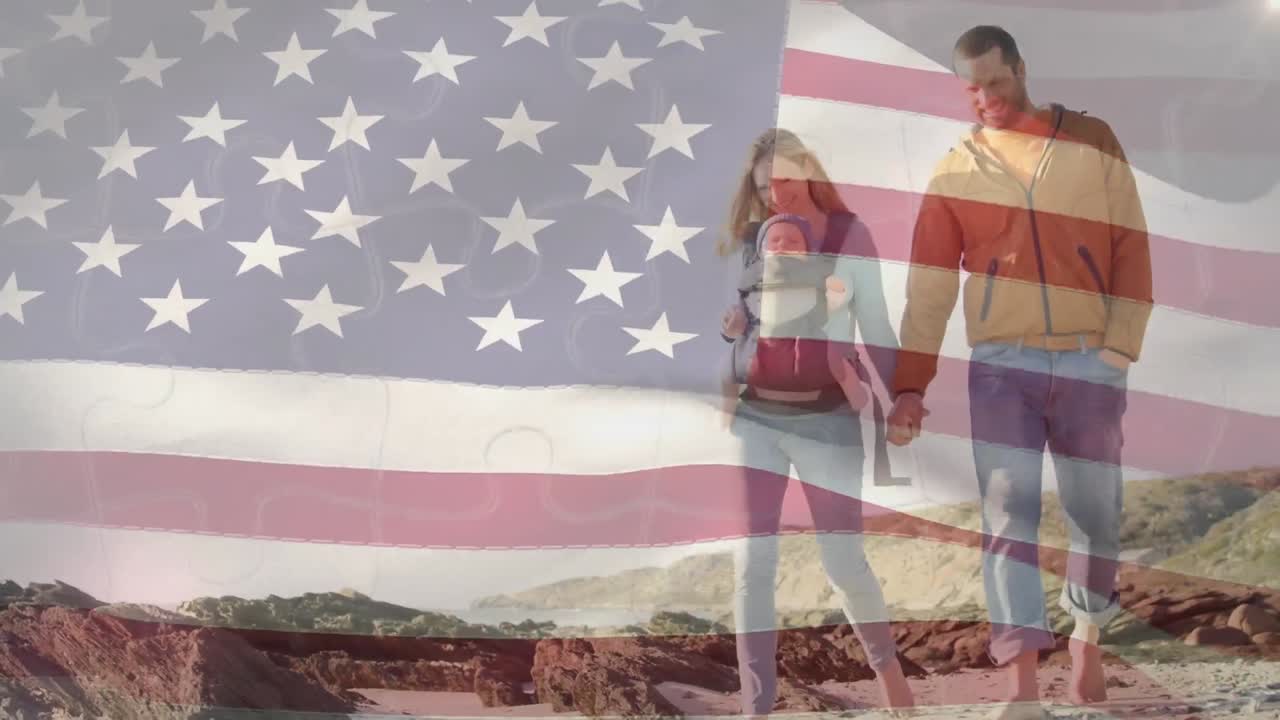 animación de agitar la bandera estadounidense contra una pareja caucásica con un bebé caminando por la playa