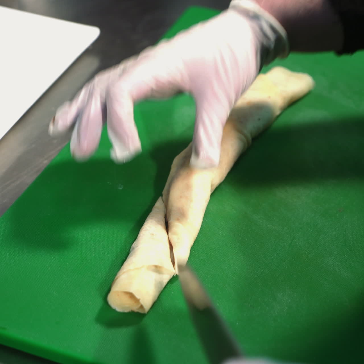 Chef cutting pancakes on a board. Tasty sweet pancake rolls with topping. Sqare video