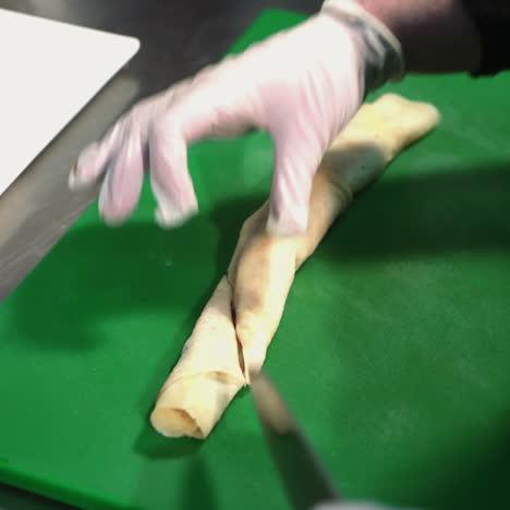 chef cutting pancakes on a board. tasty sweet pancake rolls with topping. sqare video