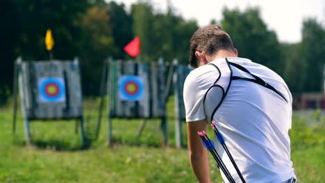 a person prepares a bow for shooting target.