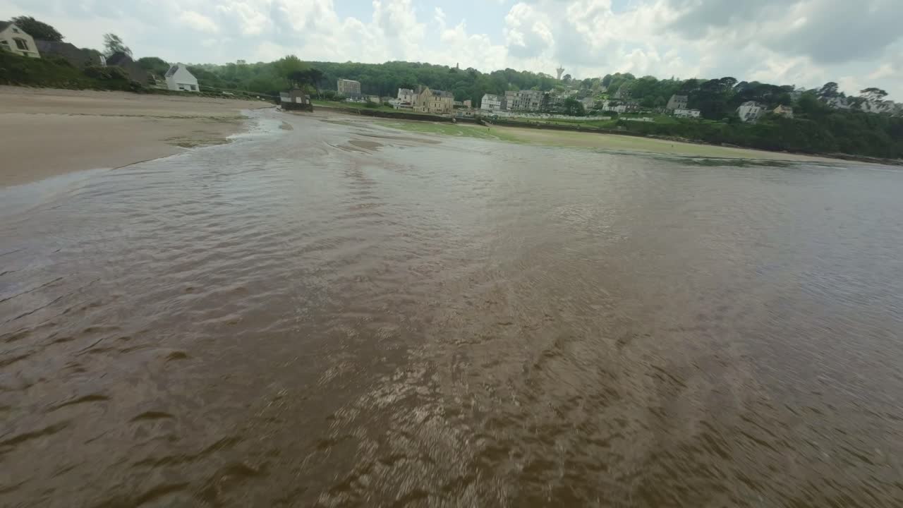 Aerial, FPV view of Ris Beach and sea in Brittany, France.