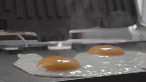 sunny side up eggs for breakfast cooked on electric grill