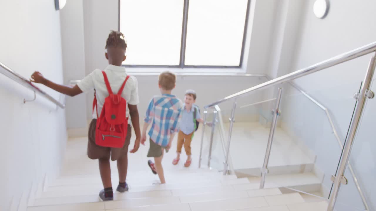 Video of diverse boys walking on stairs at school
