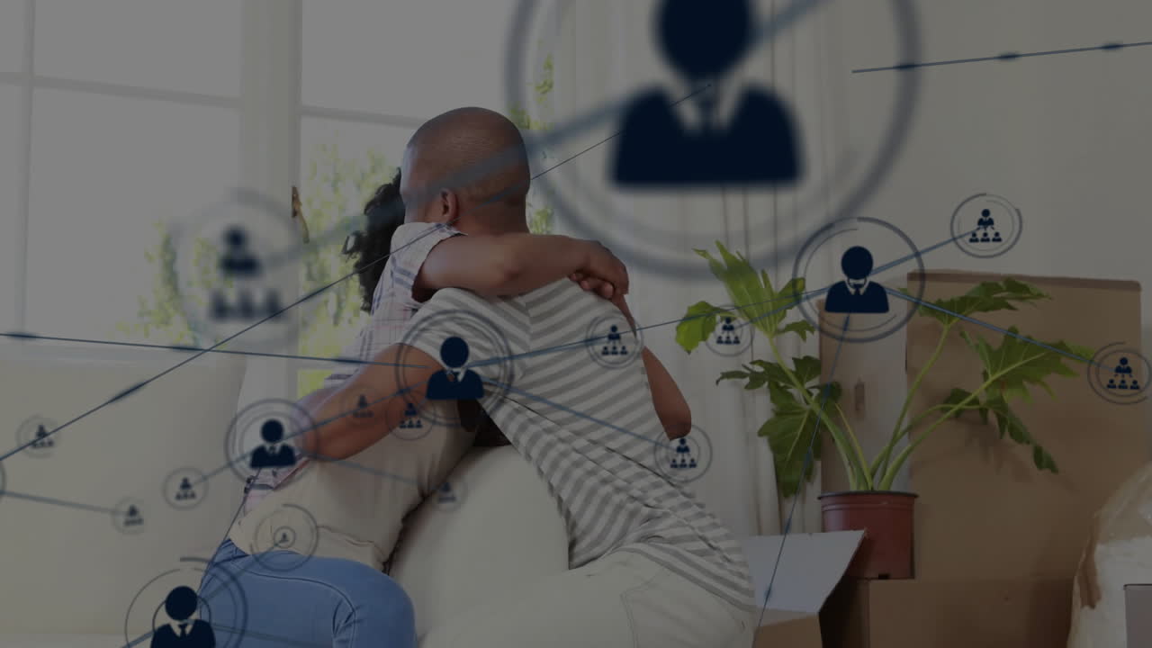 Network of connections animation over couple embracing in living room