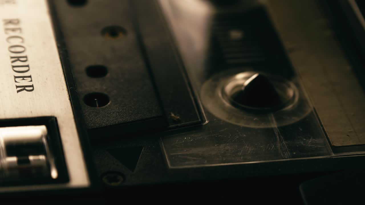 Cassette player recording tape turning, Close-up side angle
