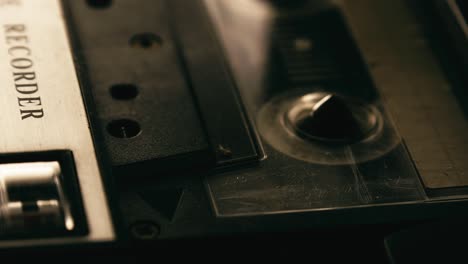 cassette player recording tape turning, close-up side angle